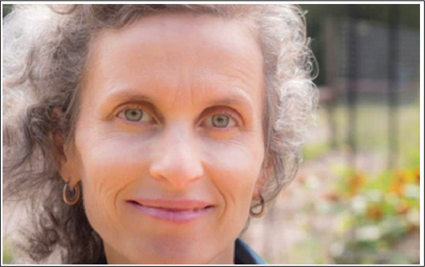 Picture of middle aged woman with glowing skin. Luminance Skincare