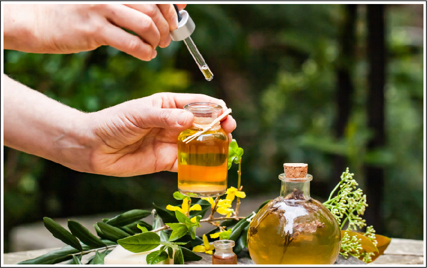 Hand filling bottle with natural organic oil