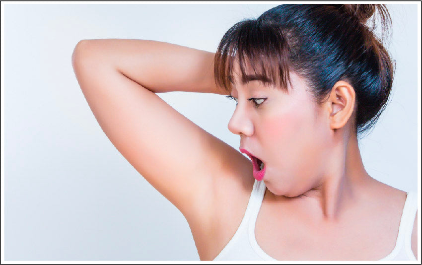 Woman Looking At Underarms - Luminance Skincare